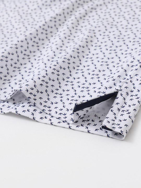 Hem slit detail of MAELREG Performance Jersey Print Polo in White Navy Swallow – comfort & movement