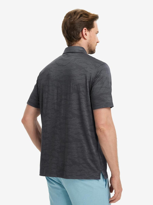 Full body front view of model wearing DARK GREY HEATHER Camo Heather Jacquard Polo, holding a golf club