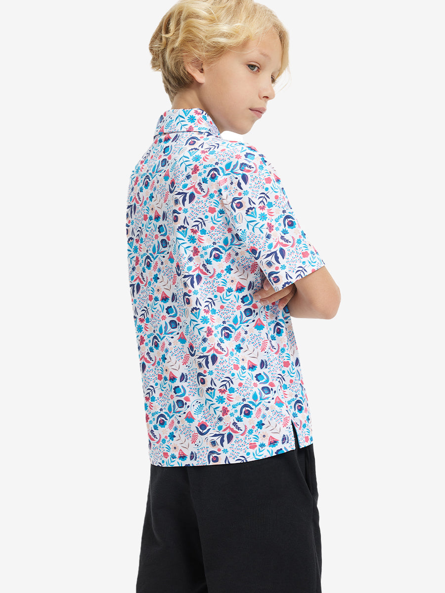 Back half-body view of boy wearing COLORFUL PLANTS Performance Print Boys Golf Polo outdoors