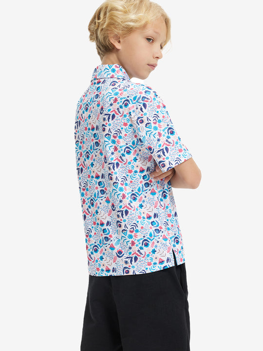Back half-body view of boy wearing COLORFUL PLANTS Performance Print Boys Golf Polo outdoors