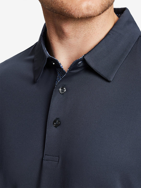 Male model wearing the Dark Grey Everyday Classic Solid Polo, front view from nose to chest