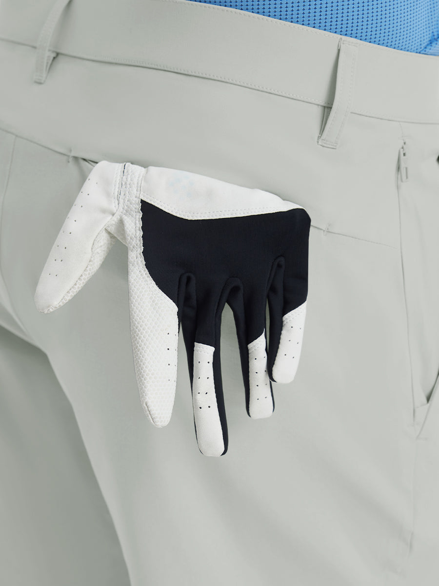 Back view of Player Fit Versatile Solid Shorts 9 Inch with golf glove tucked into right pocket – GLACIER GREY