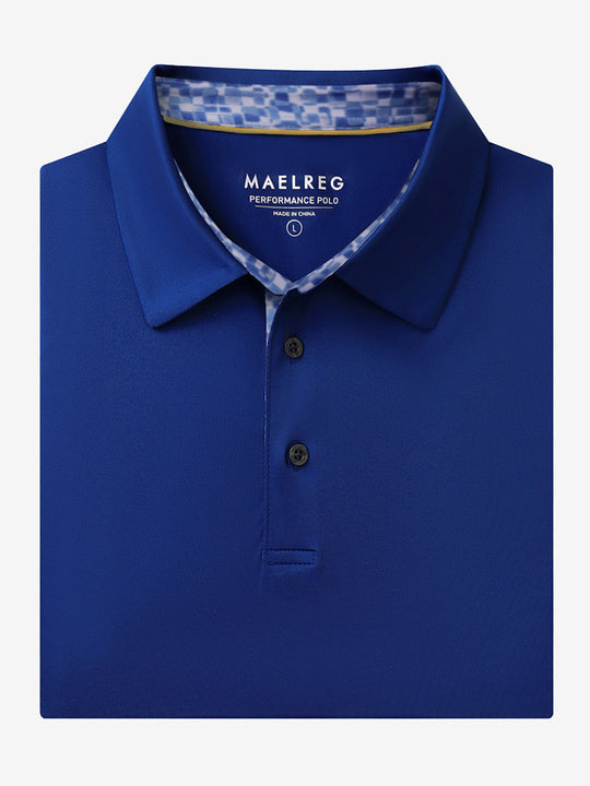 Folded Klein Blue Everyday Classic Solid Polo neatly laid out for display